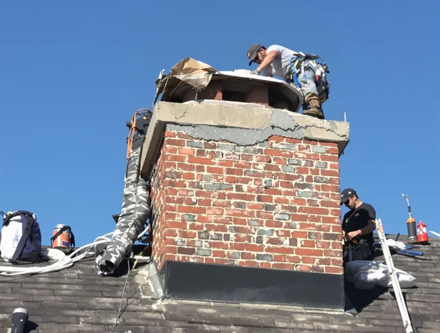 Rocky River Chimney Sweep installing a custom chimney crown in Rocky River, OH